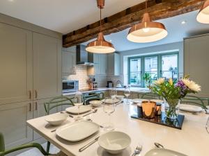 a kitchen with a large white table and chairs at 3 bed in Stow-on-the-Wold 49965 in Lower Swell