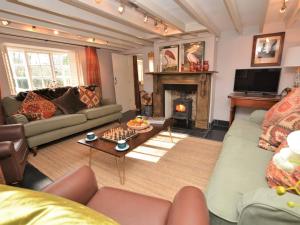 a living room with a couch and a fireplace at 4 Bed in Dorchester 56025 in Piddletrenthide