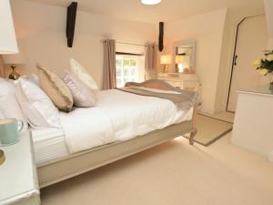 a bedroom with a bed with white sheets and pillows at 4 Bed in Dorchester 56025 in Piddletrenthide