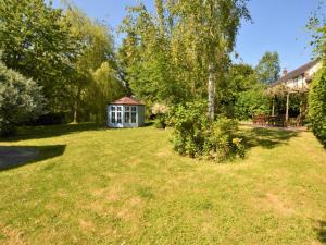 a yard with a small house in the background at 4 Bed in Dorchester 56025 in Piddletrenthide