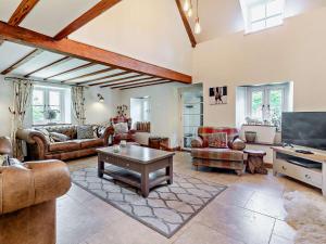 a living room with couches and a tv at 3 Bed in Brecon 56811 in Llangynidr