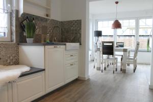 a kitchen and dining room with a table and chairs at Ferienhaus Finja in Born in Born