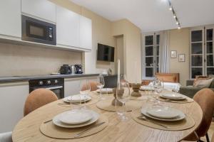 a dining room table with plates and wine glasses at Appart 6pers#2 Bedrooms#Bastille#PlaceDesVosges#AC in Paris