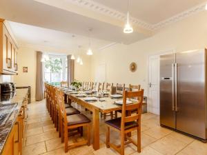 a dining room with a long table and a refrigerator at 9 Bed in Buxton 57932 in Buxton