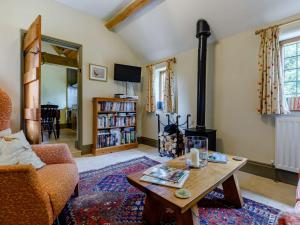 a living room with a wood stove and a table at 1 Bed in Gloucester 46502 in Lassington