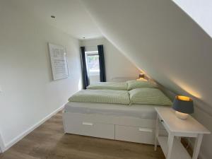 ein Schlafzimmer mit einem Bett und einer Treppe in der Unterkunft Hus Hygge in Born
