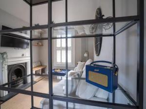 ein Glasregal in einem Zimmer mit einem Wohnzimmer in der Unterkunft Central Victorian terraced house Patio Garden - Pass the Keys in Cheltenham