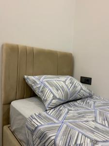 a bed with two pillows on top of it at Alp in Aksu