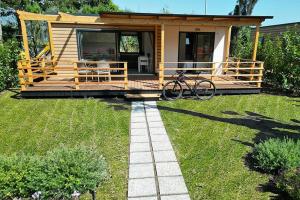 a tiny house with a bike parked in the yard at Le Dune Villaggio in Lido Di Fondi