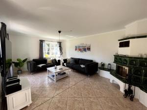 a living room with a couch and a table at Ferienhaus Fiete in Wieck in Wieck