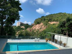 a swimming pool with two chairs and a mountain at 3 Bedroom Sea View Villa Poppy SDV343-By Samui Dream Villas in Koh Samui 