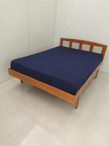 a bed in a room with a blue mattress at SEU LAR in Machadinho