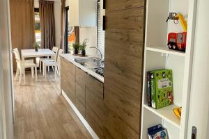 a kitchen with a sink and a kitchen with a table at Le Dune Villaggio in Lido Di Fondi