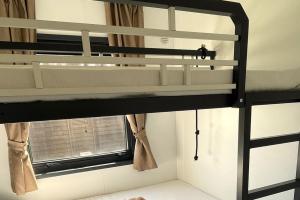 a bunk bed in a room with a window at Le Dune Villaggio in Lido Di Fondi