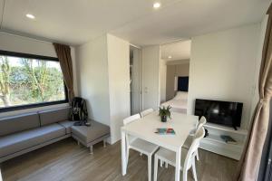 a living room with a white table and a couch at Le Dune Villaggio in Lido Di Fondi