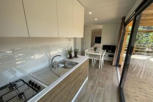 a kitchen with a sink and a stove at Le Dune Villaggio in Lido Di Fondi