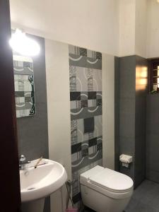 een badkamer met een wit toilet en een wastafel bij Pknhomestay kumily thekkady in Thekkady