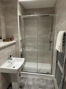 a bathroom with a shower and a sink at Stunning City View Apartment by Central Stay in Liverpool