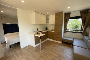 a small kitchen with a table in a room at Le Dune Villaggio in Lido Di Fondi