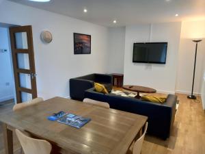 a living room with a couch and a table at Penglais Lodge in Aberystwyth