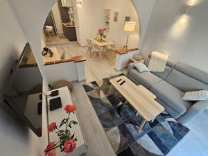 a living room with a blue couch and a table at Chez L's in Menton