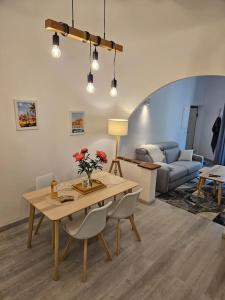 a living room with a table and a couch at Chez L's in Menton