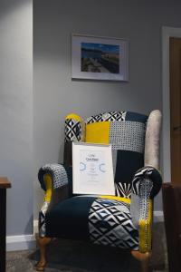 a chair with a laptop on it in a room at Erne a Rest in Enniskillen