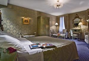 a bedroom with a bed with a book on it at Cà Rialto in Venice