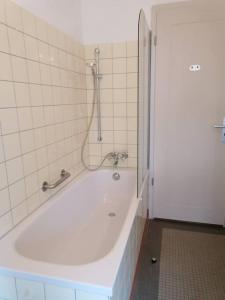 a white tub in a bathroom with a shower at exklusive Wohnung in Architekten Villa, nähe Theater in Meiningen