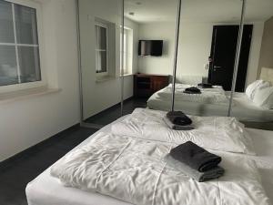 a hotel room with two beds and a mirror at Kristall Apartments in Winterberg