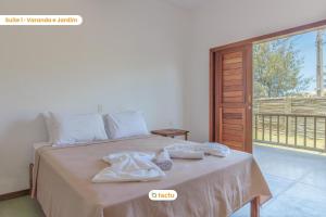 a bedroom with a bed with towels on it at Apto 100m da praia no Pontal de Maceió por Tactu in Maceio +39 photos