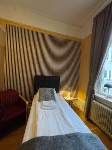 Postel nebo postele na pokoji v ubytování Lilla Hotellet