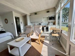 a living room with a couch and a table at Little Haven, one bed chalet in Dartmouth, Devon in Dartmouth