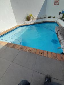 a large blue swimming pool in a building at 20 belladonna avenue Vredehoek Cape town in Vredehoek