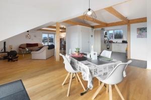 a kitchen and living room with a table and chairs at Traum mit Seeblick in Allensbach