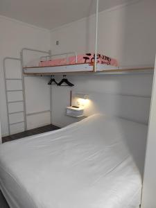 a bedroom with two bunk beds and a lamp at Alpha Hotel in Bouafle
