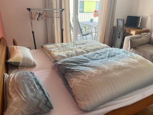two beds in a room with a living room at Beautiful apartment for you in Ulm