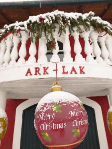 a christmas ornament is hanging on a building at ARK-LAK 
