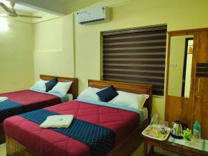 Katil atau katil-katil dalam bilik di Mystique Inn Wayanad