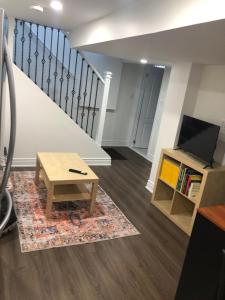 a living room with a coffee table and a staircase at Home from Home! in Brampton