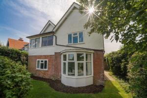 a brick house with a large window at Solenta in Yarmouth