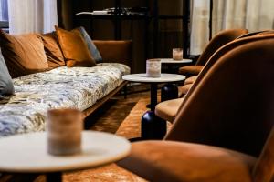 a living room with couches and tables and chairs at Clarion Hotel Grand Östersund in Östersund