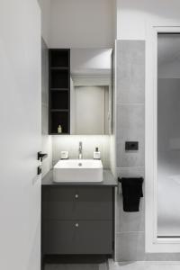 a bathroom with a sink and a mirror at Luxury Apartment con FREE PARK in Trieste +16 photos