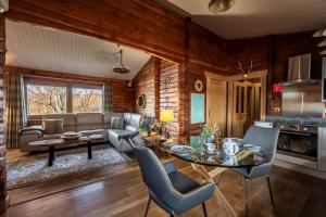 a kitchen and living room with a table and chairs at Muir-lan cabin in Lochinver