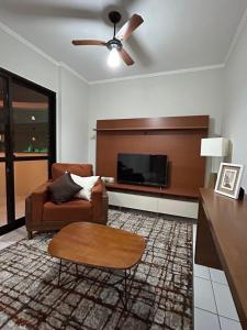 a living room with a couch and a table at Apartamento Guarujá próximo a Praia in Guarujá