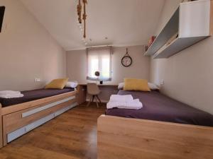- une chambre avec 2 lits et une fenêtre dans l'établissement Casa Familiar en Sevilla Este, à Séville