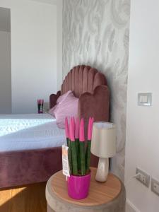 a bedroom with a bed and a table with a lamp at Labanca's Luxury center in Matera