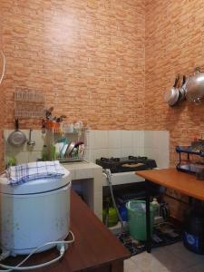 a kitchen with a sink and a stove in a room at RA Villa in Batu +7 photos