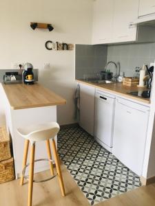 a kitchen with a counter and a sink and a stool at Studio Saint Cyr sur mer,Vue mer in Saint-Cyr-sur-Mer
