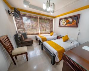 Postel nebo postele na pokoji v ubytování Hotel Aires del Quindío Armenia